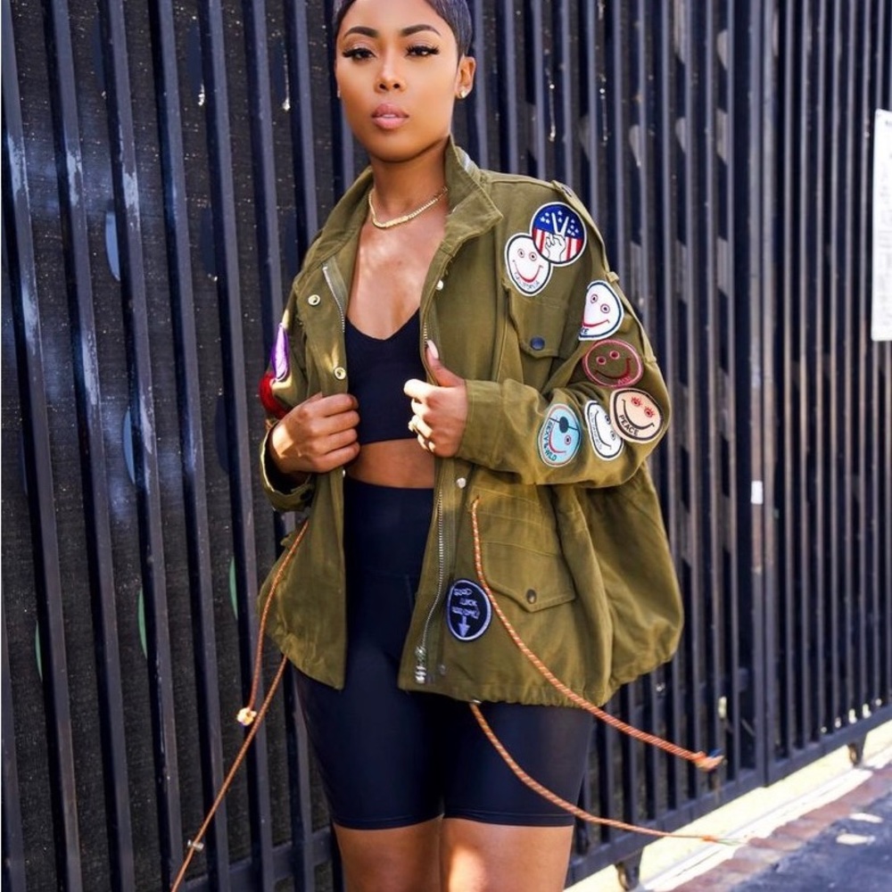 Oversized utility jacket.Smiley face patches, pockets, adjustable drawstring